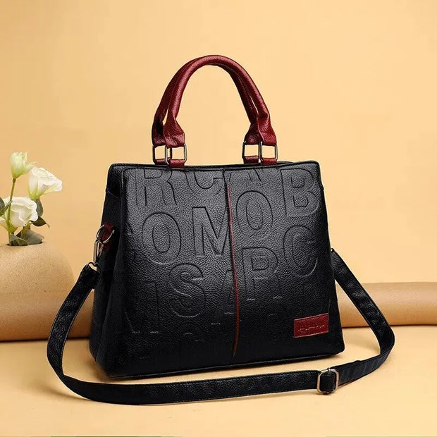 WW – Damenhandtasche aus weichem Leder mit geprägtem Buchstabendesign