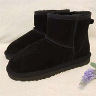 Schwarz echtleder schneestiefel mit kunstfell neben einer kleinen lavendelblume