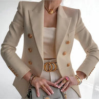 Eine Frau trägt einen beigen Blazer aus altem Geld mit goldenem Knopfdesign