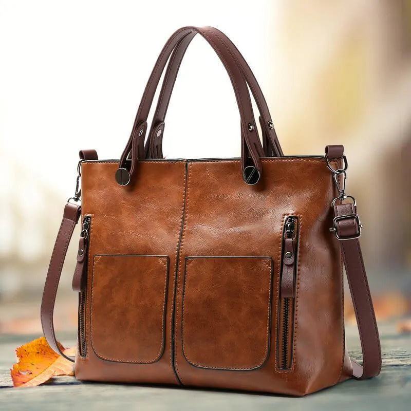 Braune Ledertasche mit verstellbarem Riemen und mehreren Taschen