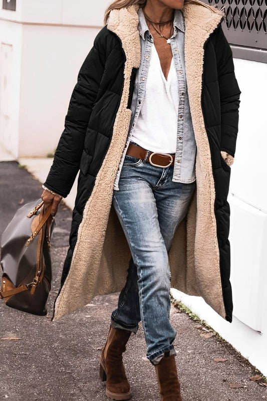 Eine frau in einem langer, bequemer schwarz mantel und jeans